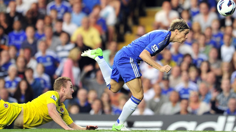 Fernando Torres gets past Alex Pearce of Reading