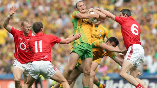 Colm McFadden of Donegal wrestles Graham Canty for the ball