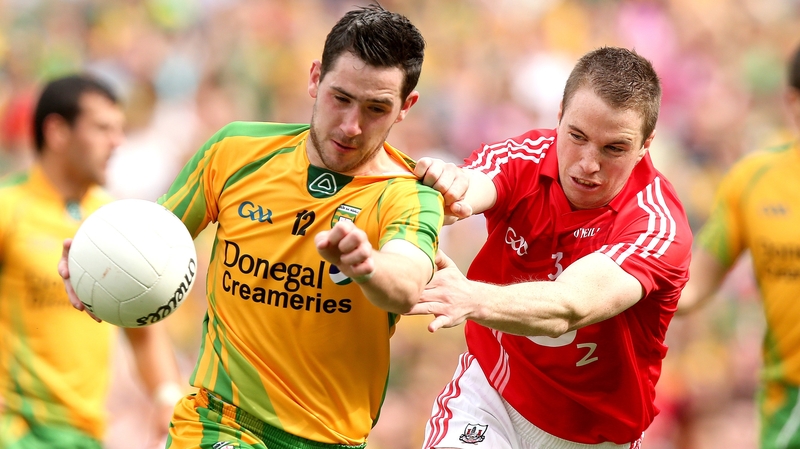 Mark McHugh of Donegal shields possession from Colm O'Neill of Cork