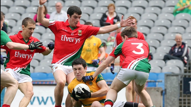 Fiachra Ward of Meath is surrounded by a posse of Mayo players