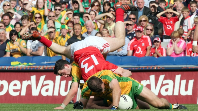 Colm O'Neill is sandwiched between Neil McGee and Mark McHugh of Donegal