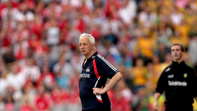 Cork manager Conor Counihan (r) and Donegal manager Jim McGuinness watch on from the sideline