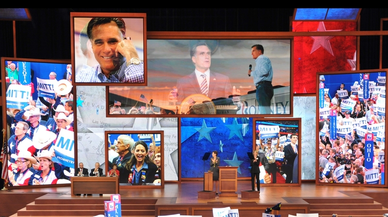 Delegates hoist posters in support of Republican presidential candidate Mitt Romney in Tampa, Florida