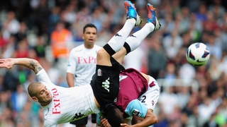 Mladen Petric of Fulham battles with Winston Reid of West Ham United