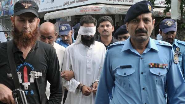 Khalid Chishti was blindfolded as he was brought to court in Islamabad