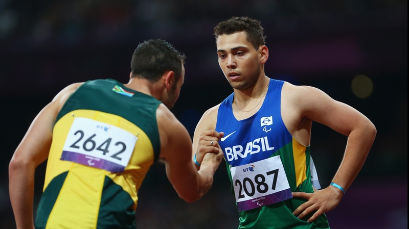 Alan Fonteles Cardoso Oliveira of Brazil is congratulated by Oscar Pistorius of South Africa
