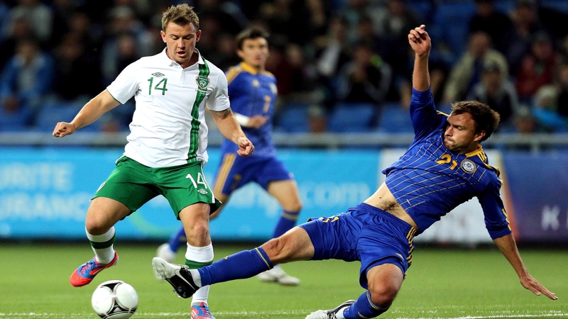 Simon Cox clashes with Mikhail Rozhkov of Kazakhstan