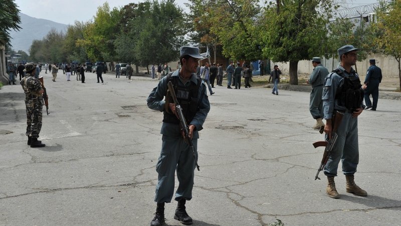 Afghan security forces stand guard at the site of a suicide attack in the city's diplomatic quarters