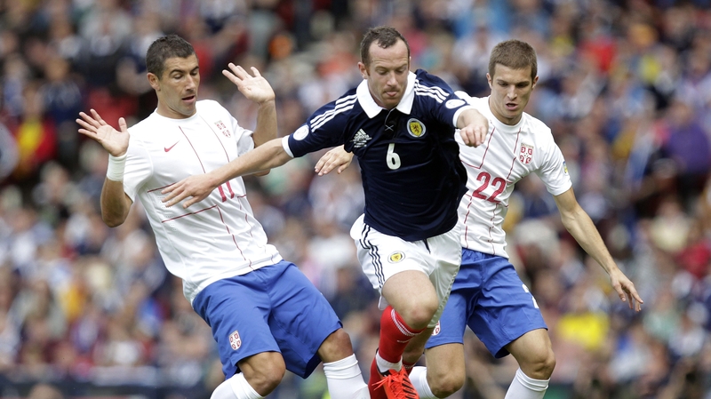 Scotland's Charlie Adam is put under pressure by Aleksandar Kolarov (l) and Darko Lazovic (r) of Serbia