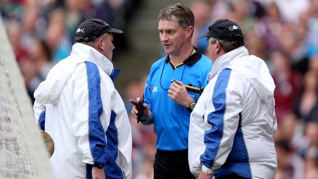 Referee Barry Kelly speaks to his umpires about a second-half shot by Richie Power of Kilkenny