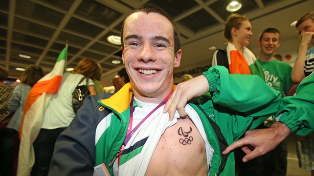 Swimmer James Scully shows off his paralymic logo tattoo.