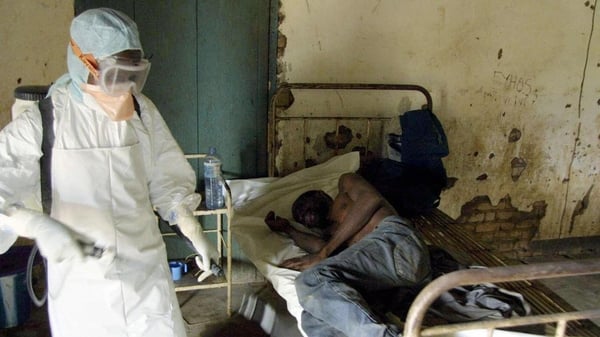This photo, taken in March 2003, shows an agent of the Congolese Red Cross disinfecting a room at a hospital