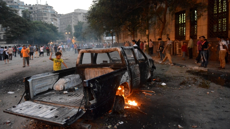 A burned-out vehicle amid a protest against the film in Cairo