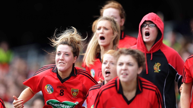The Down bench cheers on their team in the dying seconds of the game