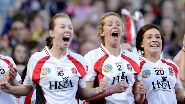 Derry substitutes celebrate their team scoring that penalty