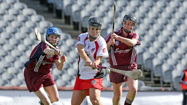 Derry's Kate McAnenly scores a goal despite the attentions of two Galway players