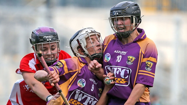 Kate Kelly of Wexford is sandwiched between team-mate Michelle O'Leary and Cork's Anna Geary