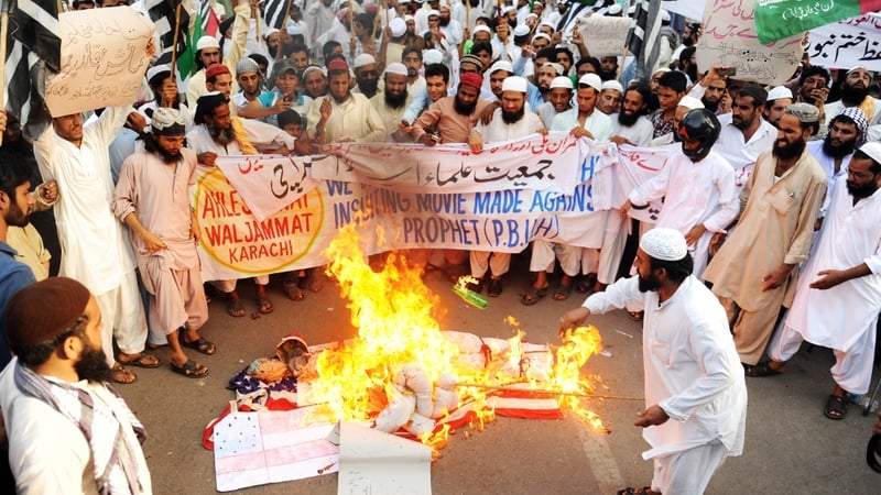 Protesters torch a US flag and an effigy of US President Barack Obama during a protest rally in Karachi