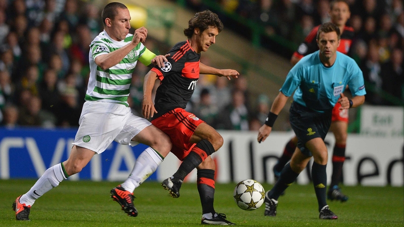 Celtic's Scott Brown battles for posession with Benfica's Pablo Aimar