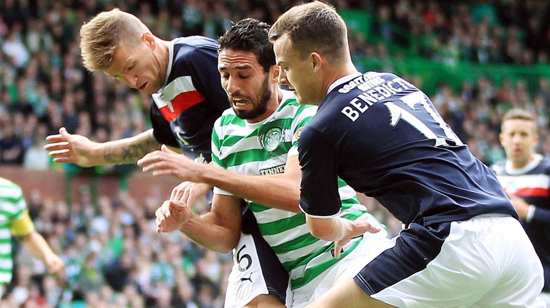 Lassad Nouioui of Celtic tries to go between Steven Milne and Kyle Benedictus of Dundee