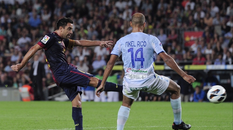 Barcelona's Xavi Hernandez opens the scoring against Granada