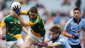 Meath's Padraic Harnan is tackled by Ross McGowan of Dublin in the minor decider