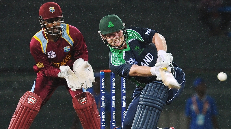 Paul Stirling plays a shot as West Indies wicketkeeper Denesh Ramdin looks on
