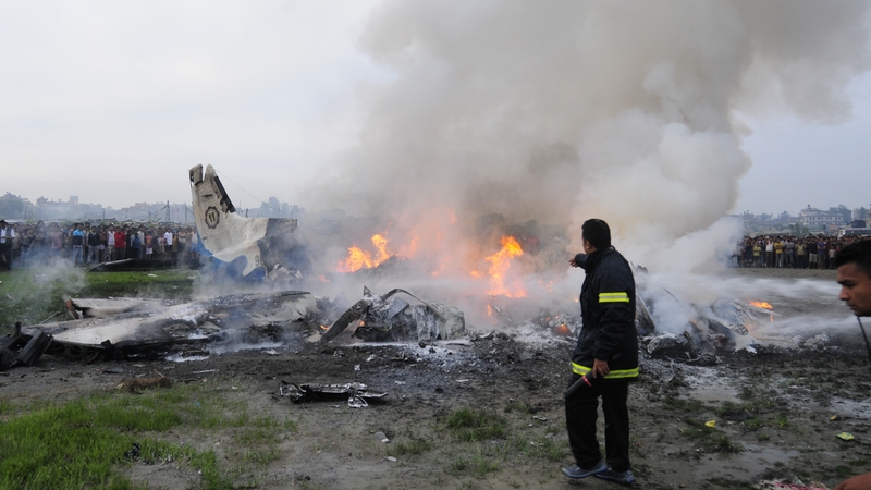 Firemen battle flames from the wreckage of the Sita Air Dornier plane crash in Manohara, near Kathmandu