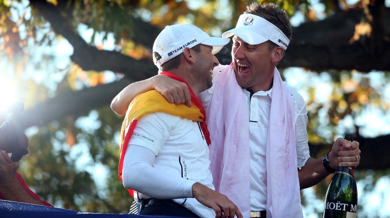 Golfer of the tournament Ian Poulter celebrates with Sergio Garcia who had a remarkable finish to beat Jim Furyk in his singles match