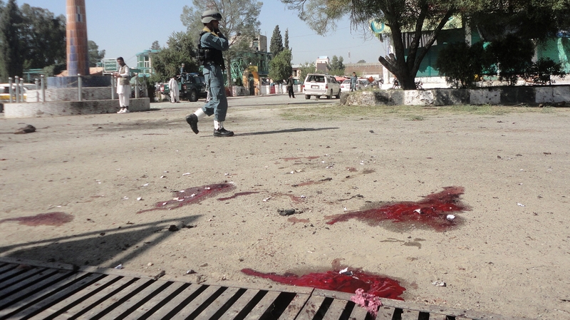 A witness said the blast involved a suicide bomber wearing police uniform