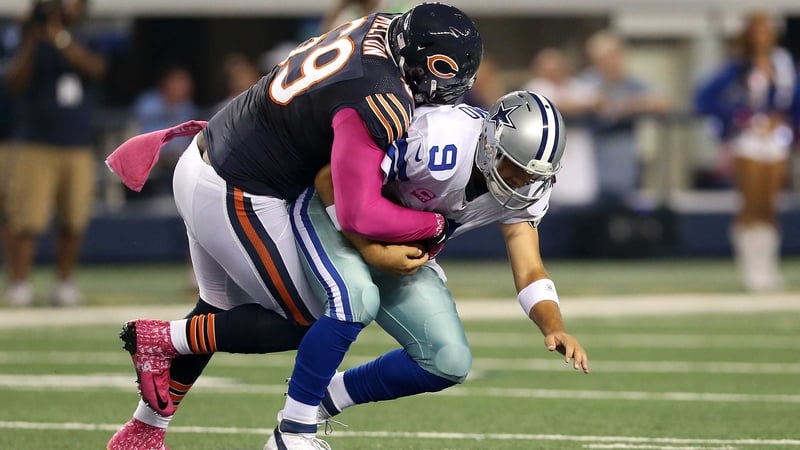 Henry Melton of the Bears sacks quarterback Tony Romo