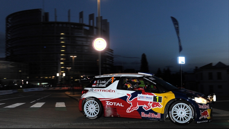 Sebastien Loeb and co-driver Daniel Elena steer their Citroen DS3 WRC in front of the European Parliament