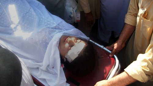 Pakistani hospital workers carry injured Malala Yousafzai, 14, on a stretcher at a hospital following an attack by gunmen in Mingora