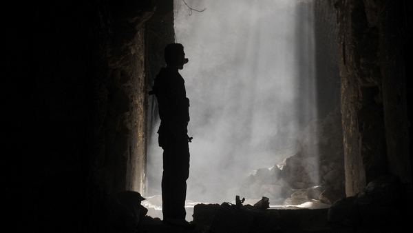 A Syrian rebel takes position during clashes with regime forces in Aleppo