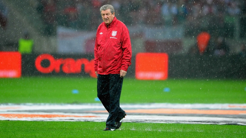 Roy Hodgson walks a soggy pitch in Warsaw
