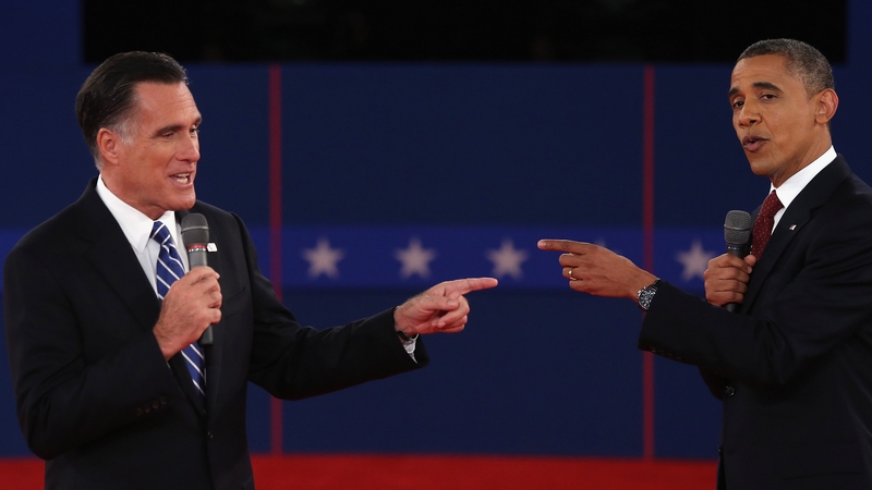 Mitt Romney and Barack Obama talk to each other during the debate at Hofstra University