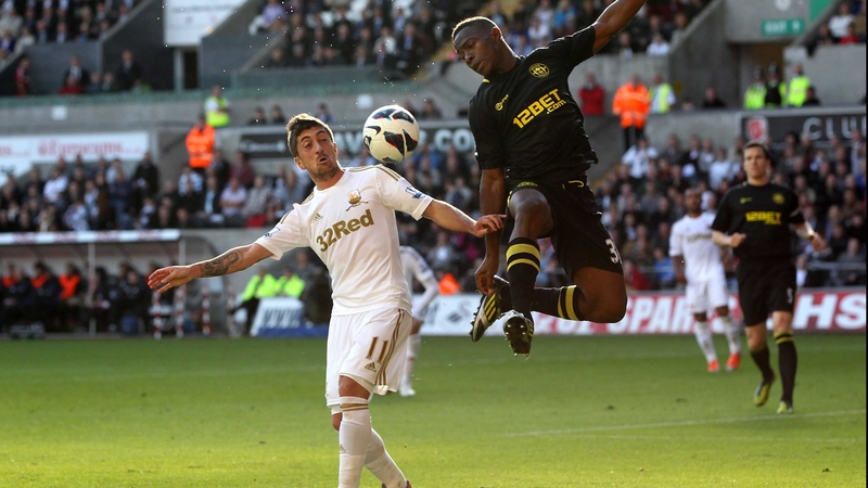 Maynor Figueroa of Wigan challenges Swansea's Pablo Hernandez
