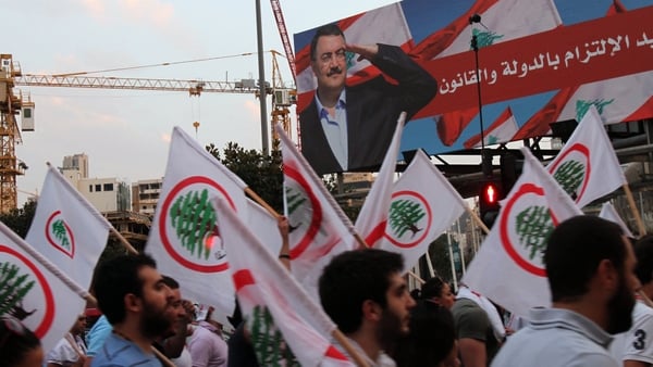 March 14 supporters take part in a protest after Friday's car bomb
