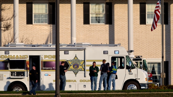 Police work outside the spa where the shooting occurred