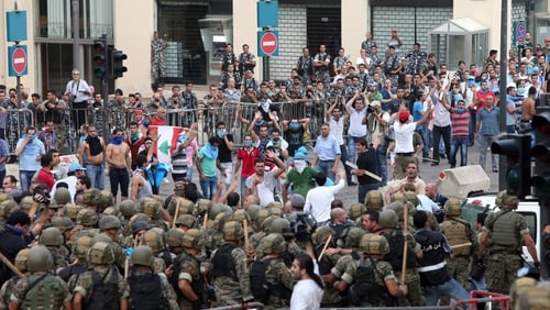 Protesters face off with Lebanese security forces as they try to storm the Government Palace in Beirut