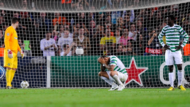 Celtic players are distraught after conceding a late goal to Barcelona