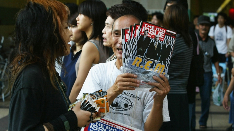 A Japanese homeless man sells The Big Issue magazine