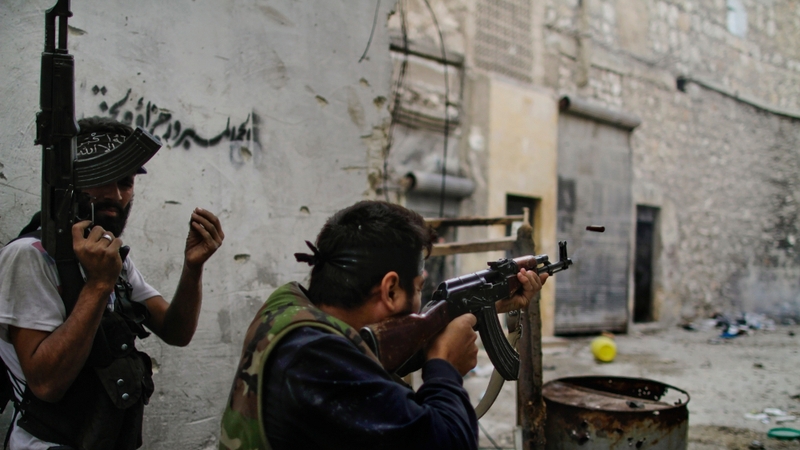Members of the Free Syria Army fire towards regime loyalist soldiers during a battle in the northern city of Aleppo