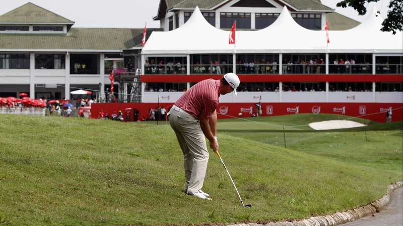 Robert Garrigus plays an approach shot towards the 18th hole