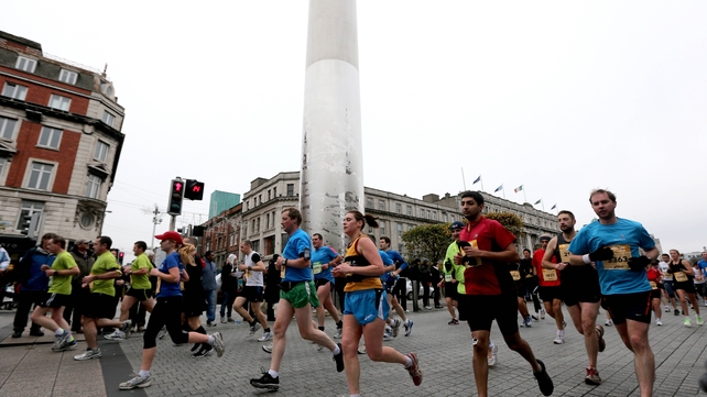 Runners on O'Connell Street with the Spire in the background