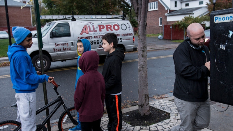 Juan Gomez, who lives in New York City, tries to make a call from a pay phone