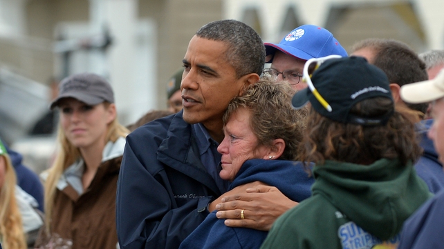US President Barack Obama comforts Hurricane Sandy victim Dana Vanzant as he visits a neighbourhood in Brigantine, New Jersey