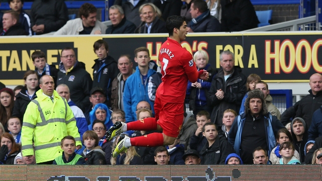 Liverpool striker Luis Suarez celebrates scoring the opening goal during the Barclays Premier League match against Everton at Goodison Park
