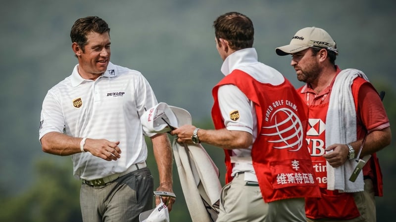 Lee Westwood shakes hands with caddies after completing the third round