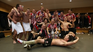 Derry players celebrate in the dressing room